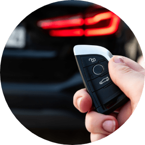 hand holding car key with remote control pushing button he is unlocking door